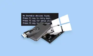 Komputer nie widzi dysku, wyświetlając komunikat "inaccessible boot device". Pendrive i dysk twardy leżą obok.