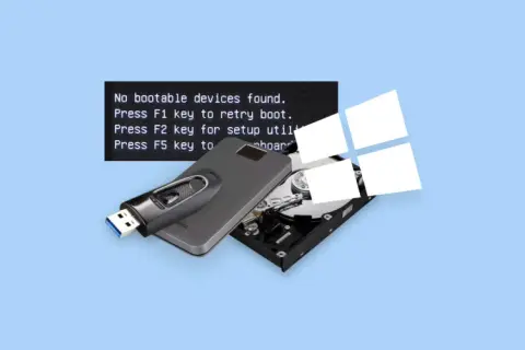 Komputer nie widzi dysku, wyświetlając komunikat "inaccessible boot device". Pendrive i dysk twardy leżą obok.