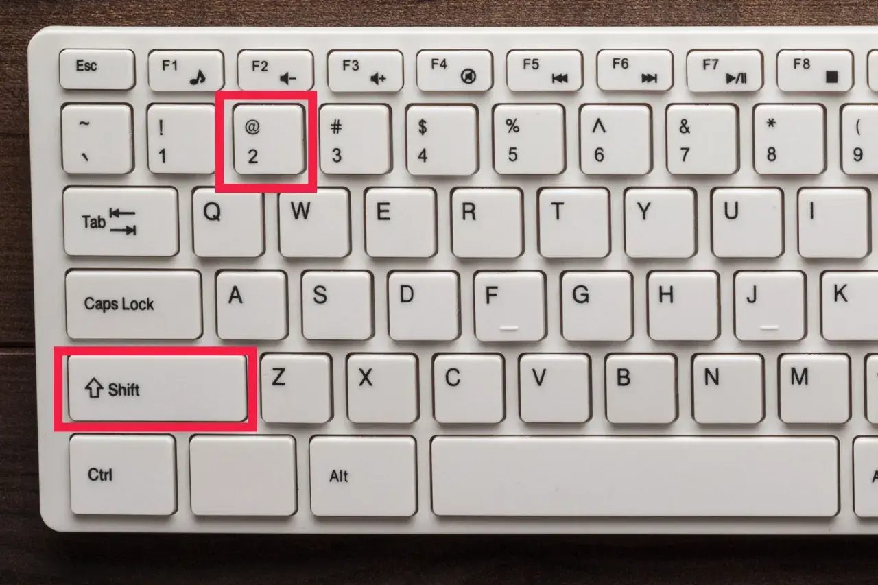 Klawiatura z podświetlonym klawiszem "@" (małpa znak) i klawiszem Shift.