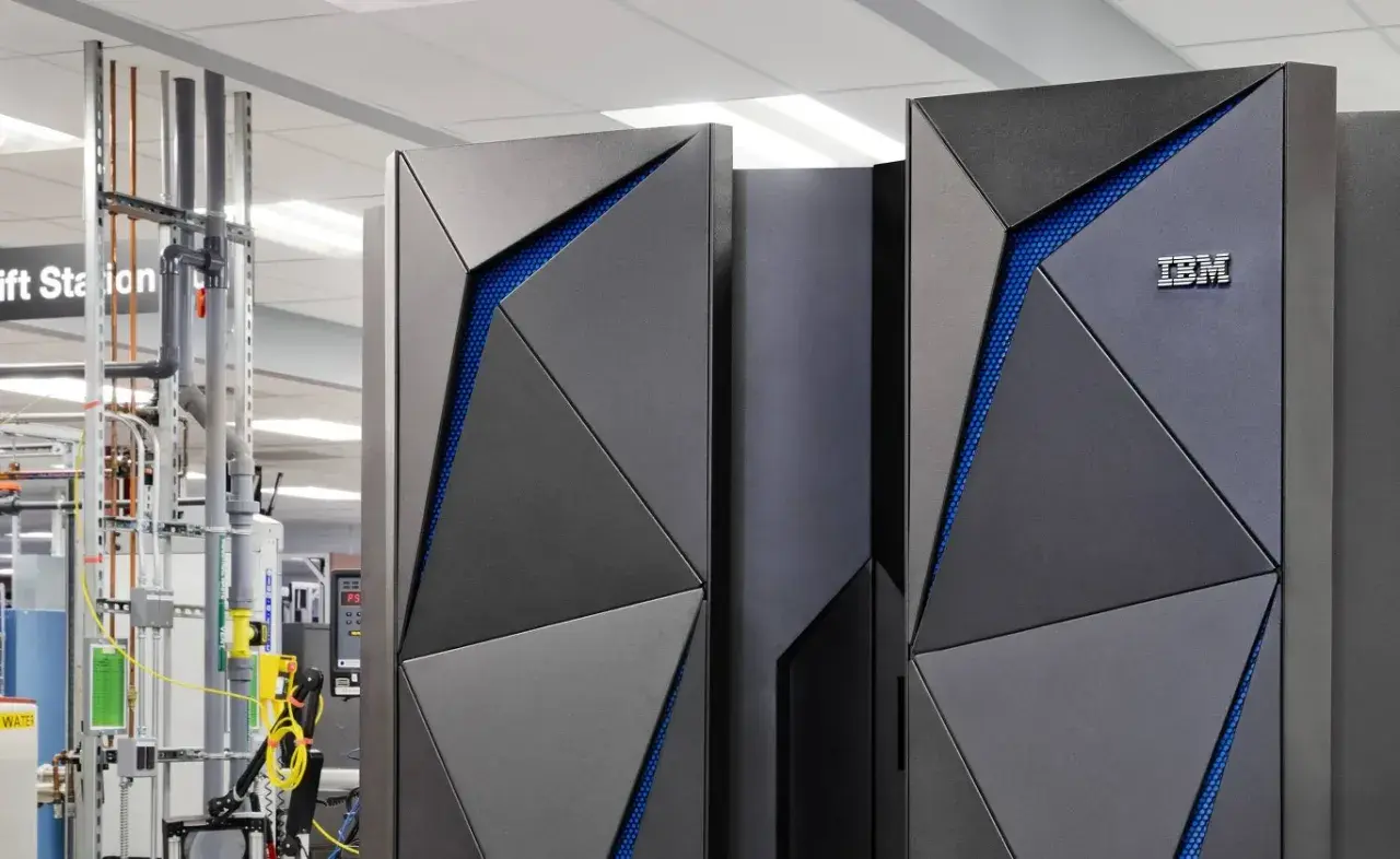 Nowoczesny mainframe IBM z niebieskimi akcentami, otoczony infrastrukturą techniczną.